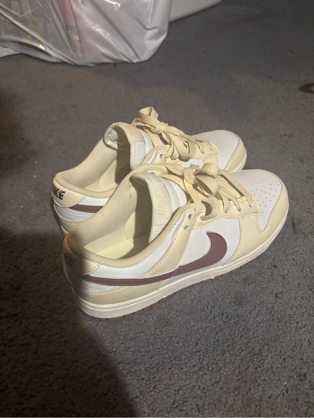 Nike Women's Low-Top Sneakers in Cream with Brown Swoosh